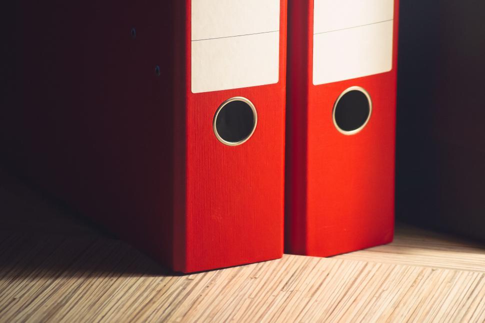 Free Image of Two red binders standing on shelf 