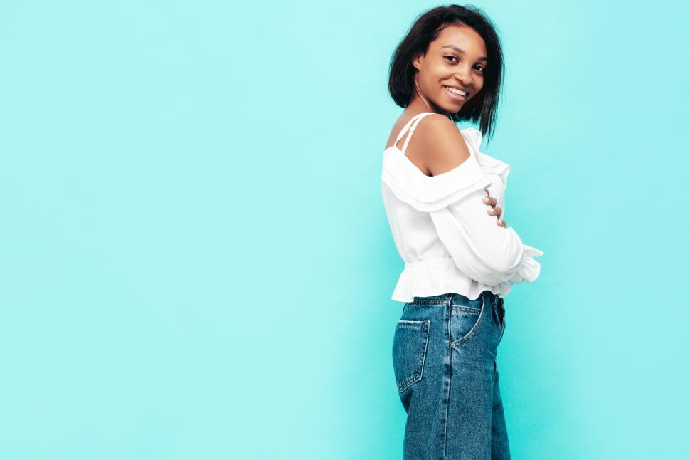 Free Image of A woman smiling with arms crossed 