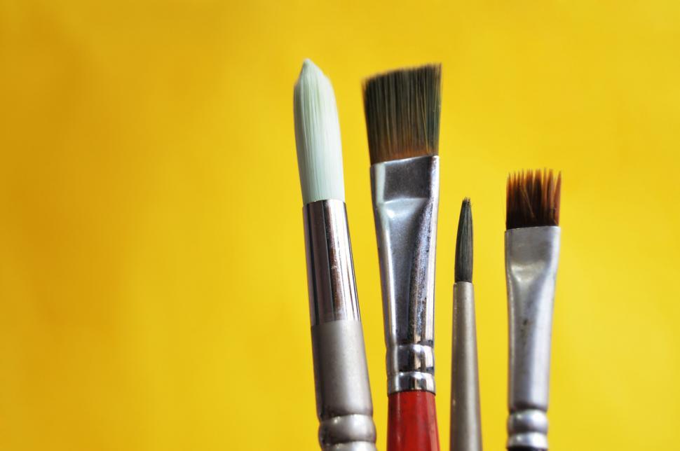 Free Image of Paintbrushes with yellow background 