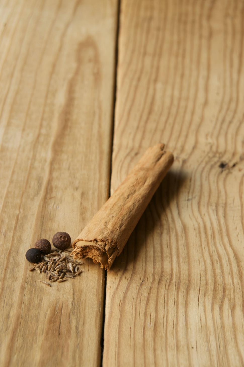 Free Image of Cinnamon sticks and spices on wooden surface 