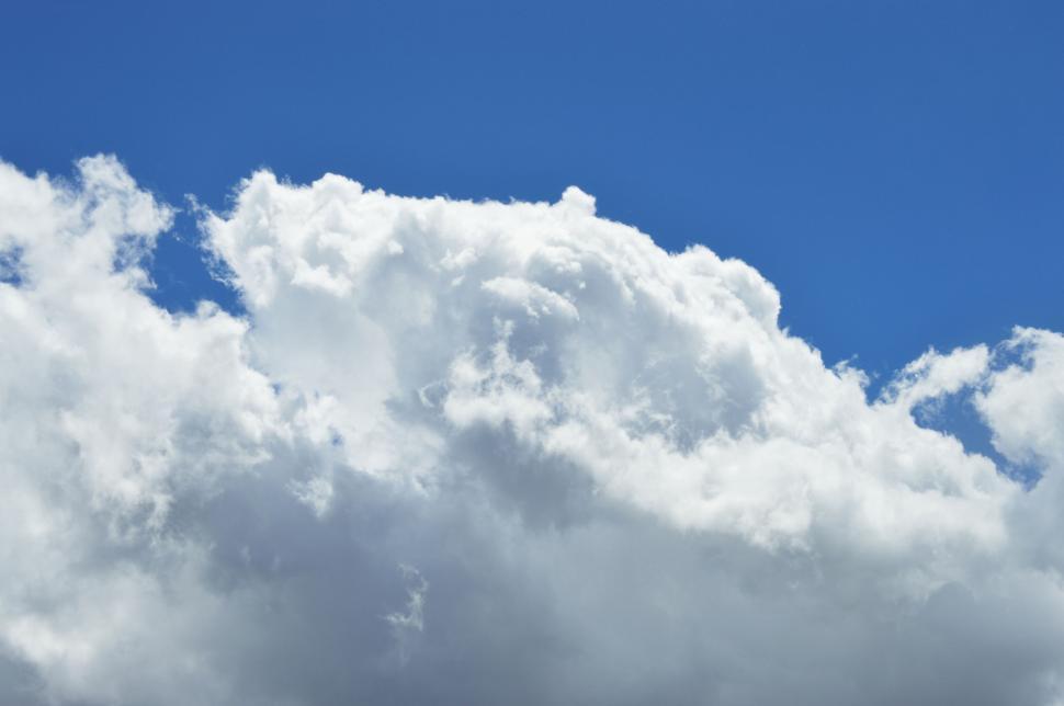 Free Image of Fluffy white cloud in a blue sky 