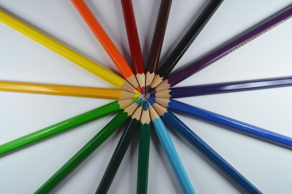Free Image of Circle of colored pencils on white background 