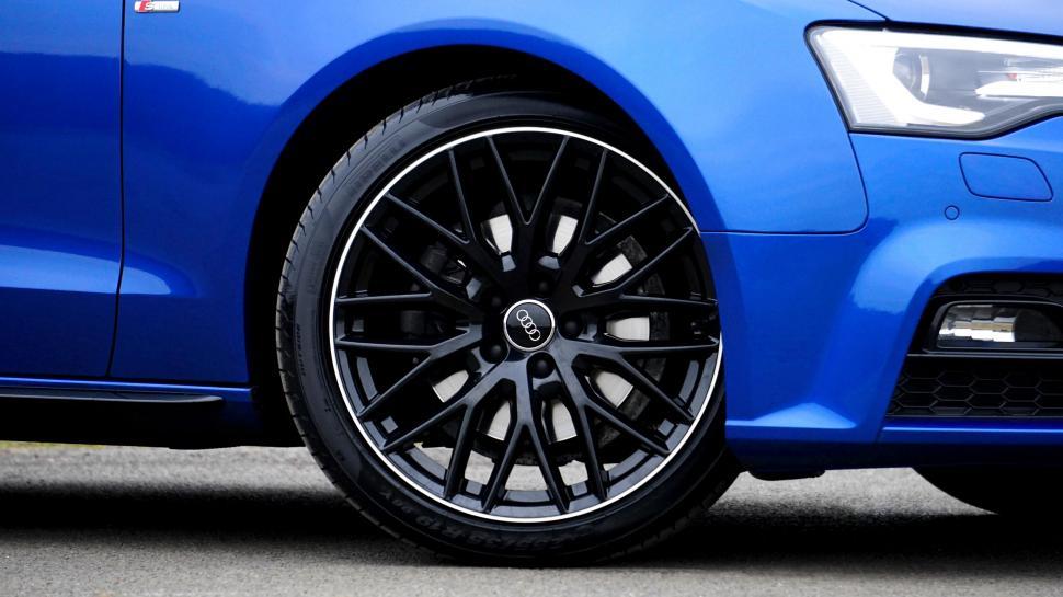 Free Image of Blue car wheel close-up with sporty design 