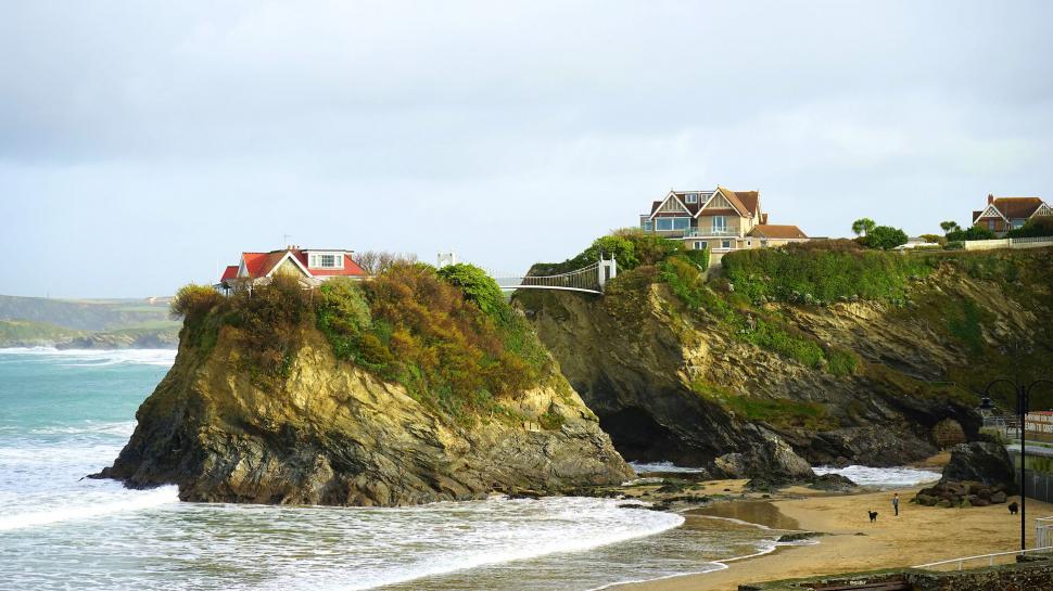 Free Image of Scenic view of a coastline with cliffside houses 