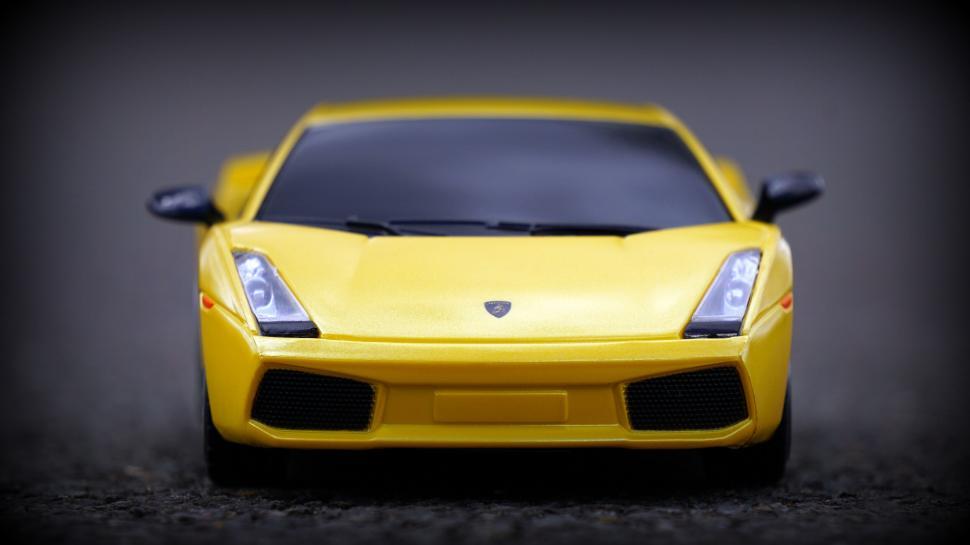 Free Image of Yellow Toy Lamborghini Model on Dark Surface 