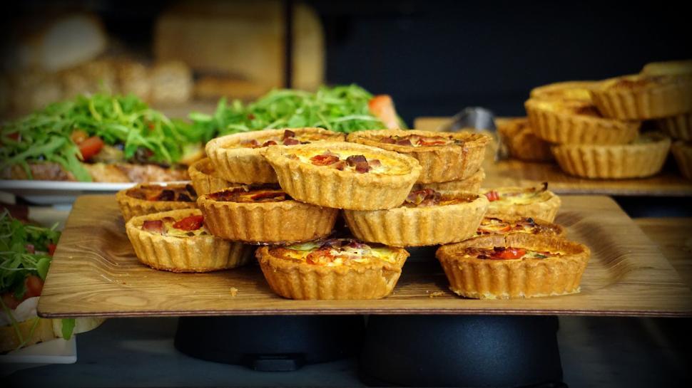 Free Image of Selection of savory quiches on wooden stand 