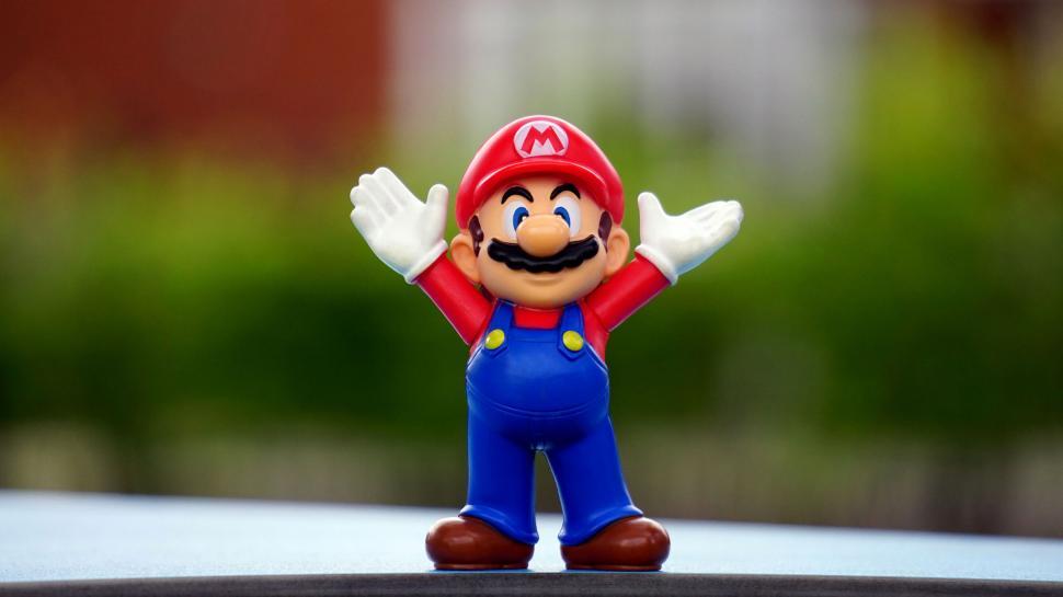 Free Image of Mario figurine with open arms on a table 
