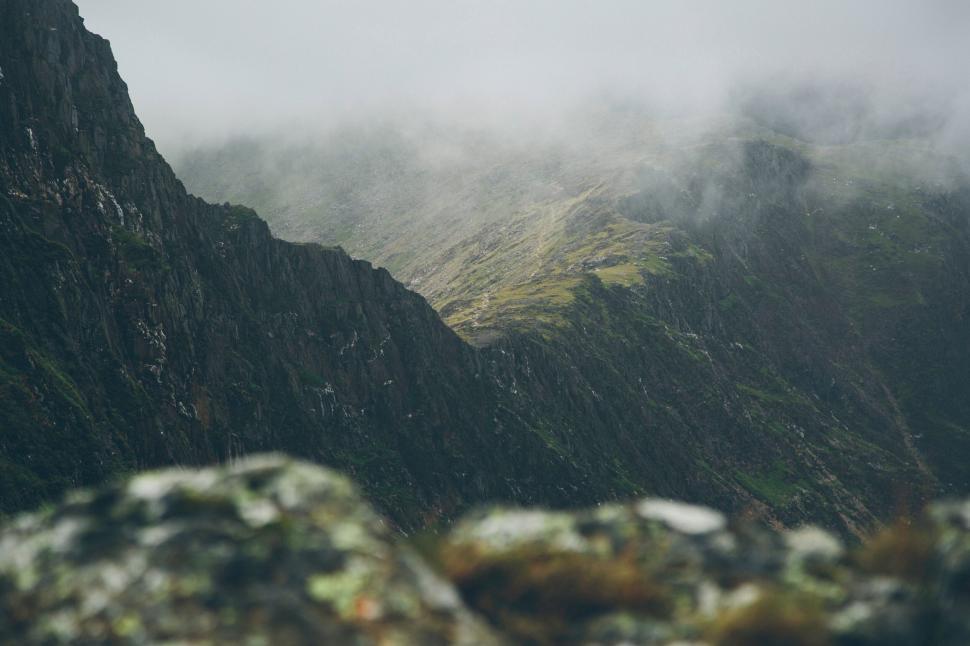 Free Image of Misty mountain range with rocky outcrop 