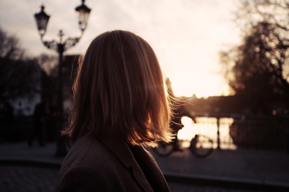 Free Image of Silhouette of a woman against a sunset 
