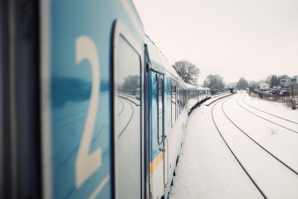 Free Image of Train curving on snowy tracks perspective 