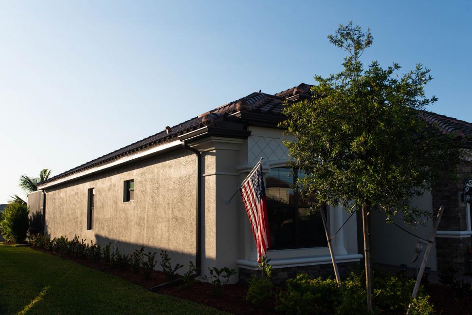 Free Image of American flag outside a suburban house at dusk 