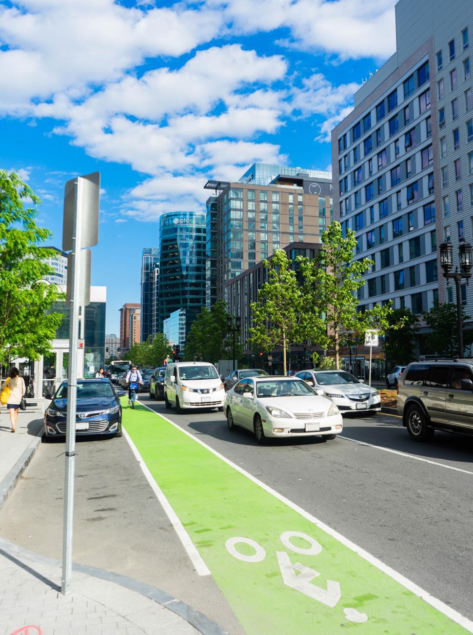 Free Image of Busy city street with colorful bike lane 