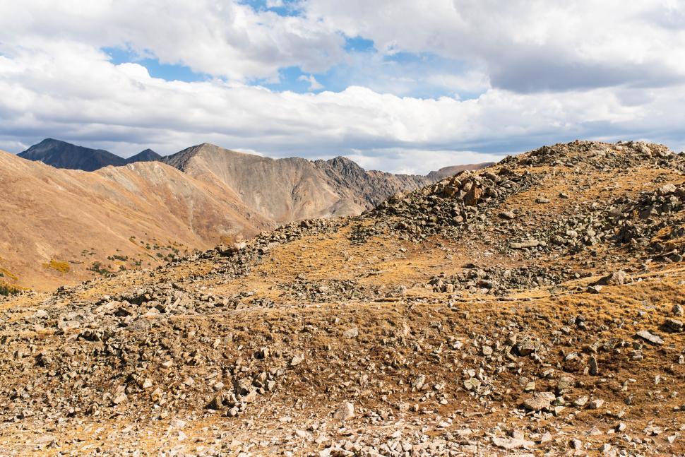 Free Image of Rugged mountain terrain under a cloudy sky 