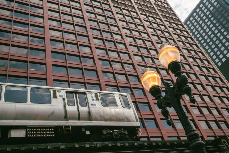 Free Image of Train passing by with city building backdrop 