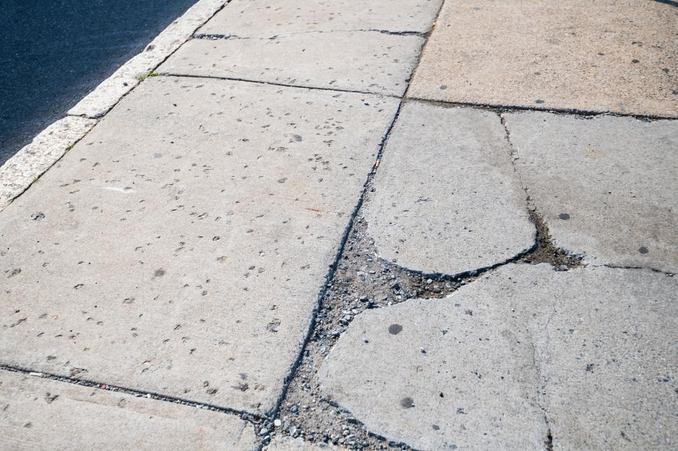 Free Image of Cracked sidewalk pavement close-up view 