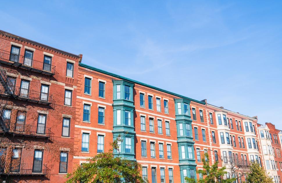 Free Image of Colorful Row Houses Under Blue Sky 