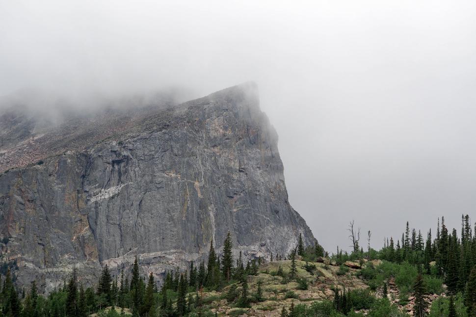 Free Image of Majestic fog-covered mountain cliff 