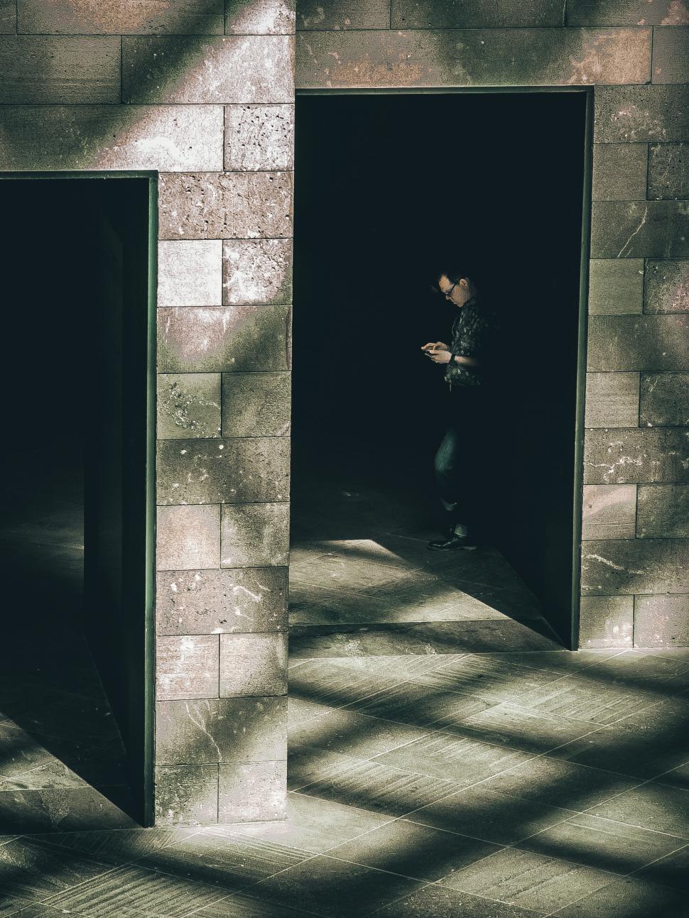 Free Image of Shadowy figure in building doorway 