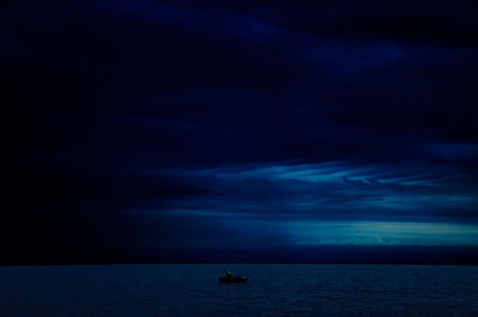 Free Image of Lonely boat in a vast nighttime sea 