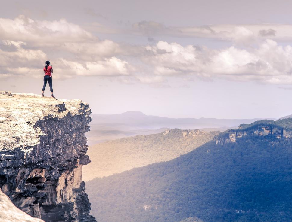 Free Image of Adventurous person standing on a rocky cliff 