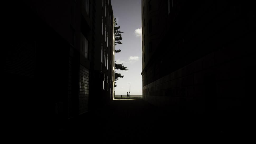 Free Image of Silhouetted figure in a narrow passage 
