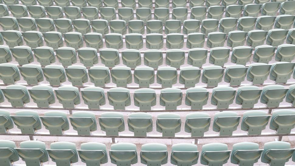 Free Image of Empty stadium seats in uniform rows 