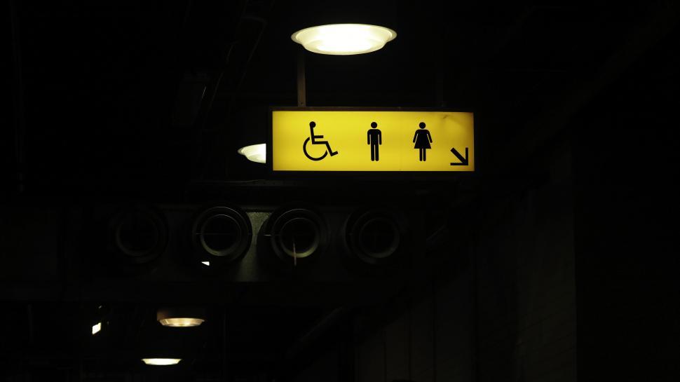Free Image of Public restroom sign illuminated at night 