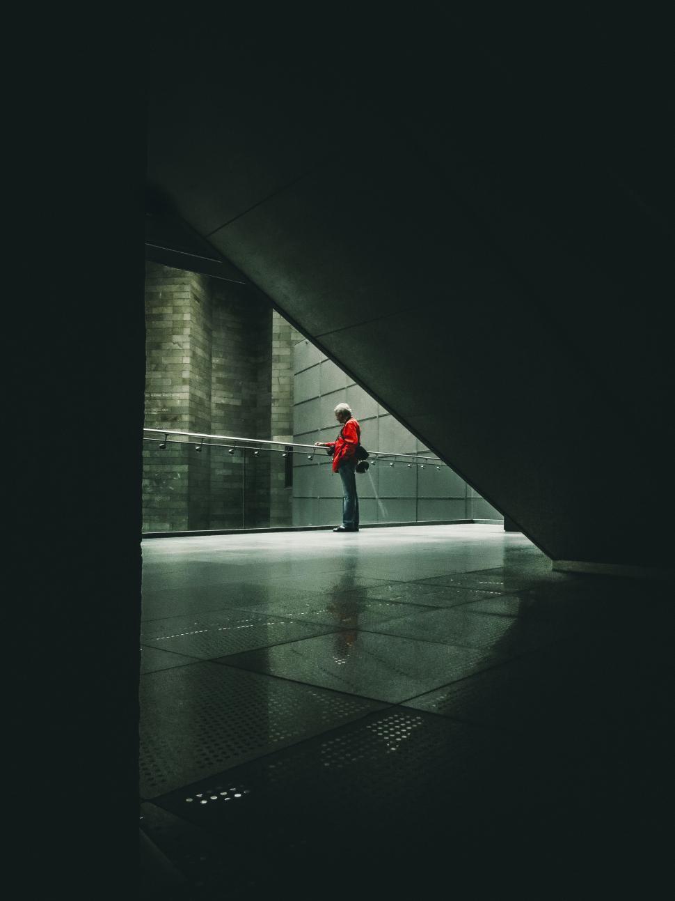 Free Image of Silhouette of person in red on modern architecture 