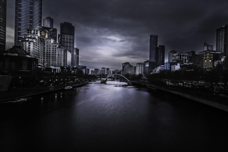 Free Image of Eerie urban skyline with river cutting through 