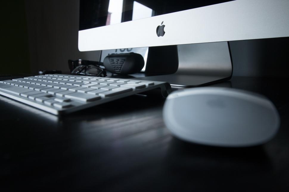 Free Image of Apple computer on a dark wooden desk 