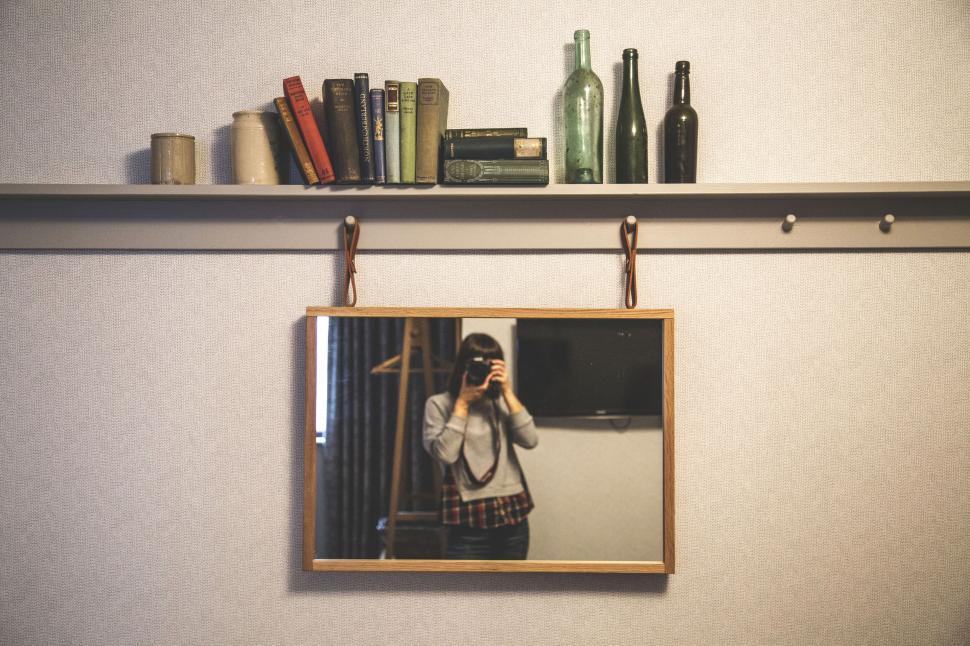 Free Image of Vintage shelf mirror with photographer s reflection 