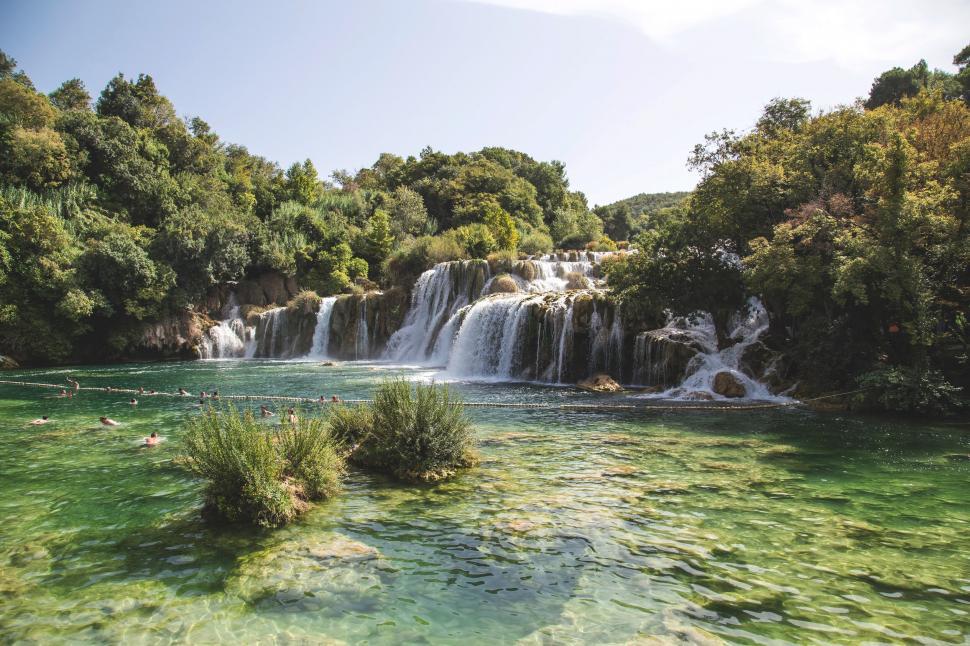 Free Image of Krka Waterfalls surrounded by lush greenery 