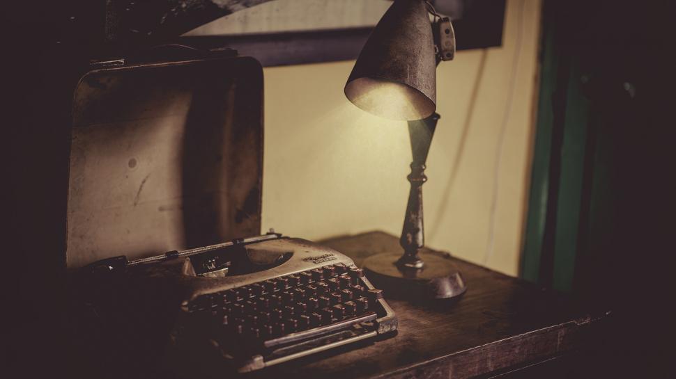 Free Image of Vintage typewriter and lamp on a wooden desk 