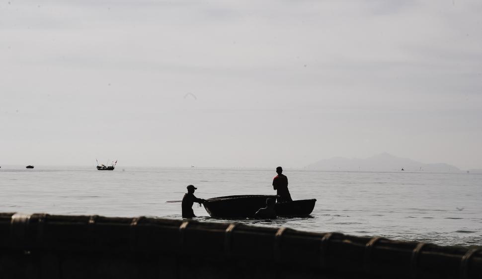 Free Image of Silhouette of fishermen in a small boat 