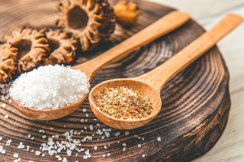 Free Image of Sea salt and spices on wooden spoons and board 