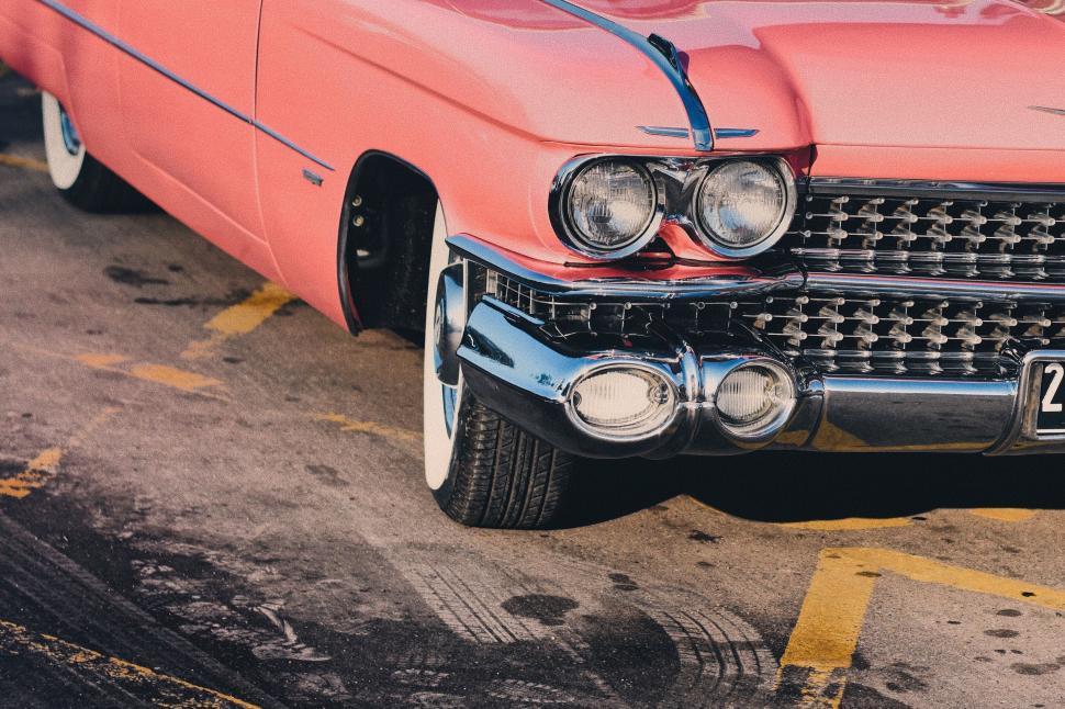 Free Image of Classic pink Cadillac on a parking lot 
