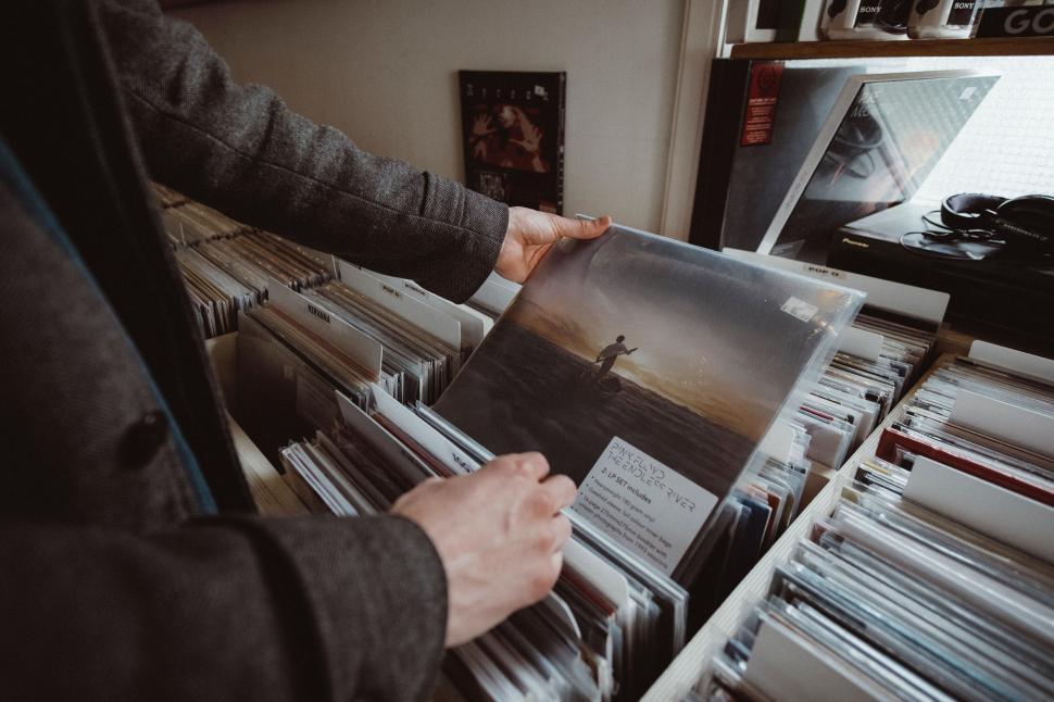 Free Image of Person browsing through vinyl records in a store 