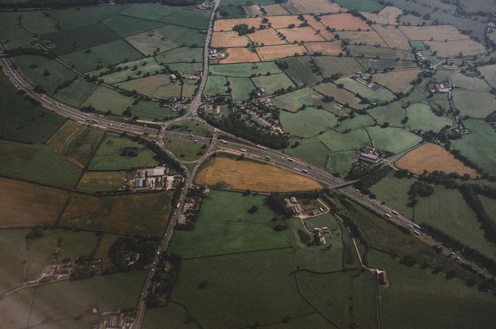 Free Image of Aerial view of a lush countryside road 