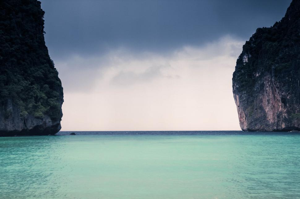 Free Image of Dramatic seascape with towering cliffs and calm sea 