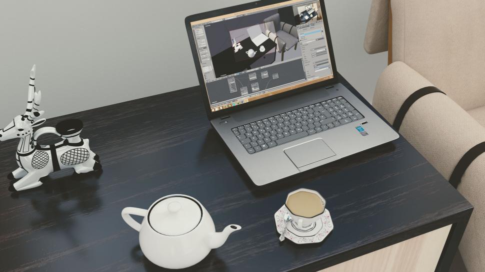 Free Image of Laptop with 3D modeling software on desk 