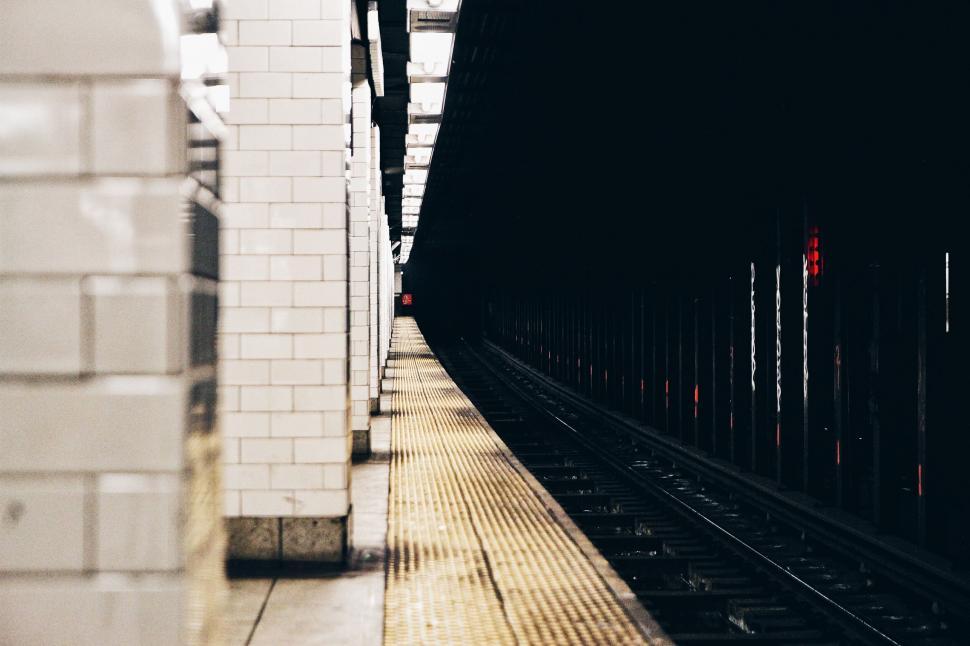 Free Image of Dimly lit subway station platform perspective 