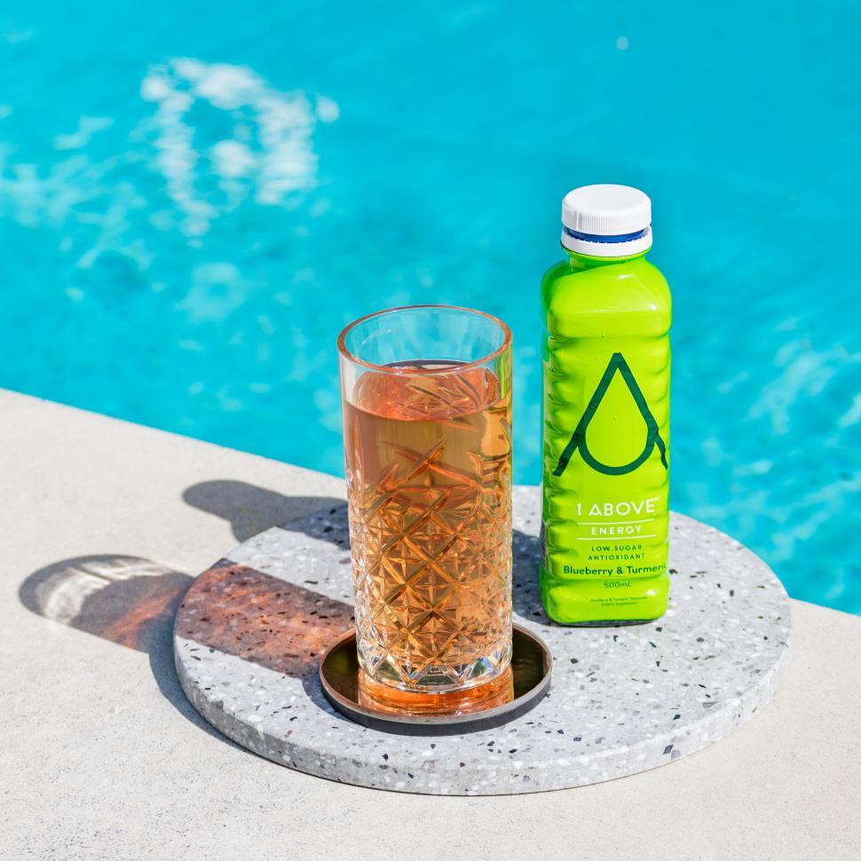 Free Image of Poolside refreshment with drink and water bottle 