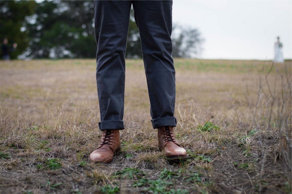Free Image of Man in a field with leather shoes and pants 