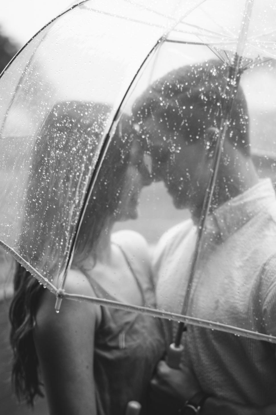 Free Image of Intimate couple under a transparent umbrella 
