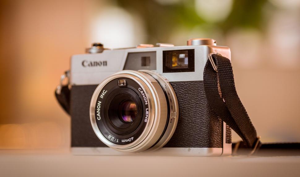 Free Image of Vintage Canon Camera on Wooden Table 