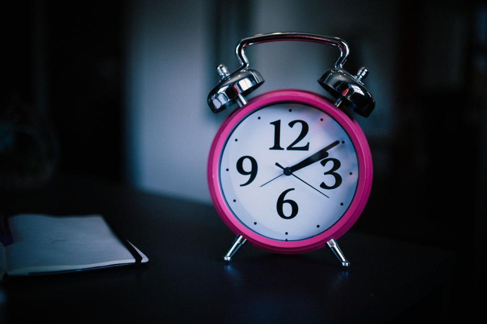 Free Image of Pink Alarm Clock on Dark Background 