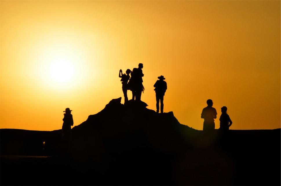 Free Image of Silhouetted People on Hill at Sunset 
