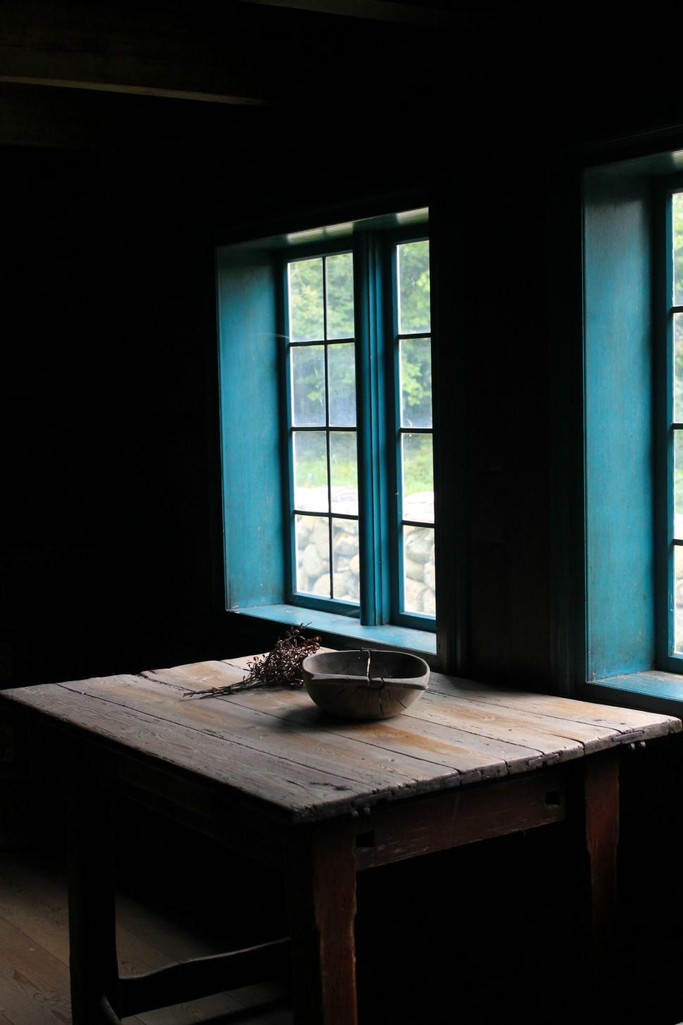 Free Image of Rustic wooden table by a cabin window with view 