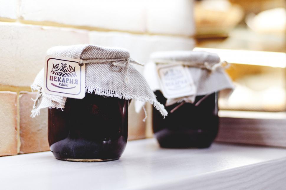 Free Image of Two jars of homemade preserves on a ledge 