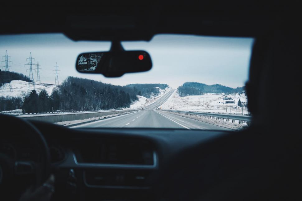 Free Image of View of a snowy highway from inside a car 